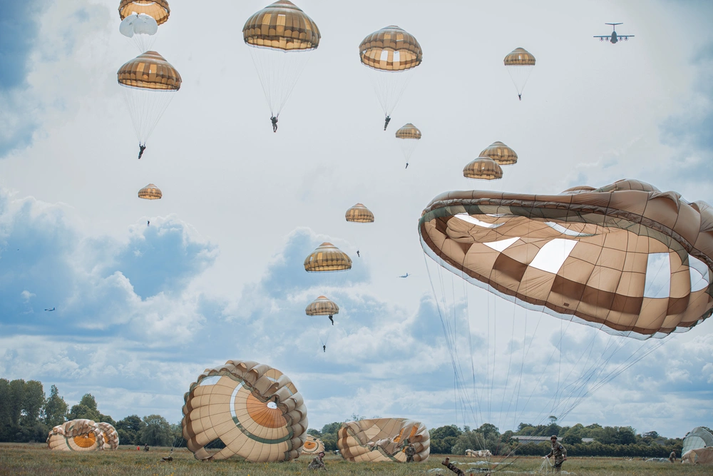 soldiers with parachutes coming down from the sky